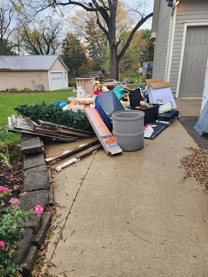 Dumpster being loaded with debris for Estate Cleanout Dumpster Rental in Hermon